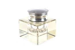 An Asprey & Co silver and tortoiseshell mounted glass inkwell.