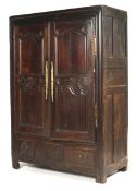An 18th century French Oak cupboard with a pair of doors before shelves having three panels to