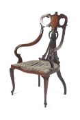 A late 19th century black walnut Art Nouveau open armchair with stringing and inlay,