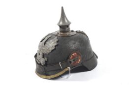 A WWI (World War One ) German helmet / Pickelhaube with ' FR' eagle crest brass trim and chin