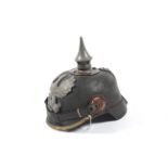 A WWI (World War One ) German helmet / Pickelhaube with ' FR' eagle crest brass trim and chin