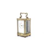 An early 20th century brass carriage clock ( Timepiece ) of serpentine shape,