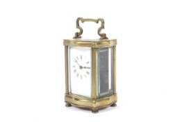 An early 20th century brass carriage clock ( Timepiece ) of serpentine shape,