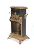 A late 19 th C Parrafin Conservatory Heater in the French manner standing on 4 feet with a Veritas