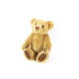 A late 20th century Steiff Teddy Bear with blonde Mohair covering,, stitched nose, label to ear,