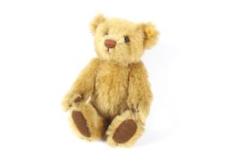 A late 20th century Steiff Teddy Bear with blonde Mohair covering,, stitched nose, label to ear,
