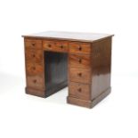 A circa 1900 Mahogany Knee Hole Pedestal Desk with three short frieze drawers,