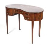 An Edwardian Kidney Shaped ladies Writing Desk the mahogany with satinwood cross banding and