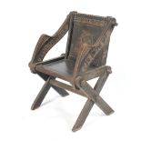 A late 19th century carved oak Glastonbury chair.