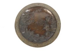 A circa 1900 Japanese cast bronze charger. Featuring a stork in flight over figures, diameter 37.