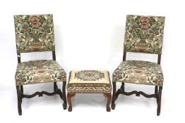 A pair of 20th century chairs and a footstool.