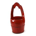An Oriental red painted wooden well bucket.