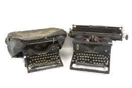 Three vintage manual typewriters and three telephones.
