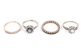 Four rings including a garnet eternity ring.