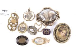 A collection of eight 19th century and later mourning brooches.
