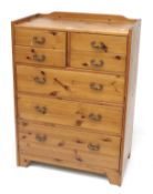A contemporary pine chest of drawers. Of four short and three long graduated drawers.