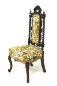 A Victorian heavily carved upholstered dining chair.
