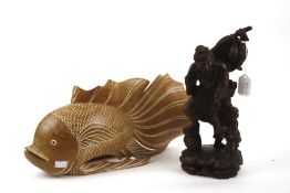 Two contemporary oriental wood carved figures. Comprising a fisherman and a large fish. Max.