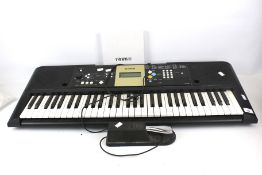 A Yamaha electronic piano keyboard. YPT-220 with a foot pedal FC4.