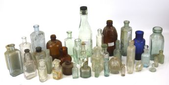 A collection of assorted vintage glass bottles.