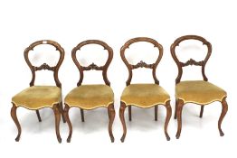 A set of four 19th century mahogany framed balloon back dining chairs.