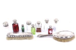 Six silver or white metal mounted glass scent and perfume bottles.
