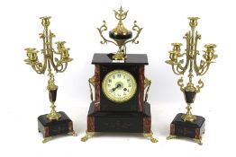 An early 20th century French black slate clock garniture.