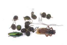 A carved horn 'cicada' brooch and a collection of Victorian beetle jewellery.