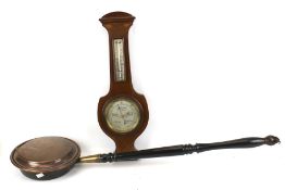 A copper bed warming pan and wall banjo barometer.