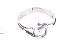 A Mexican 'Sterling Silver Taxco' abstract cross-over bangle.
