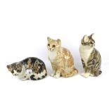 Three vintage Winstanley pottery cat figures.