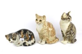 Three vintage Winstanley pottery cat figures.