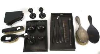 A collection of ebony dressing table items and a silver mounted brush.