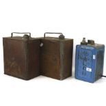 Three vintage petrol cans, one converted into a lamp.