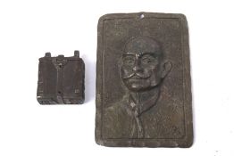 A novelty cast metal box and a metal plaque. The box modelled as a rucksack, L4.