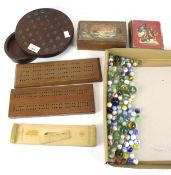 An assortment of vintage games. Including marbles, cards, a chess set, etc.