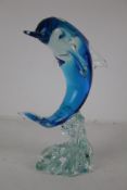 A large Murano glass dolphin. Coloured blue and positioned on a wave, H35.