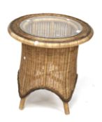 A contemporary wicker and glass topped table.
