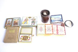 An assortment of vintage games. Including playing cards, dice, etc.