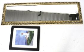 A full length bevel edged gilt wall mirror and a framed print.