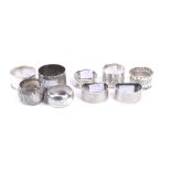Nine silver and white metal napkin rings.