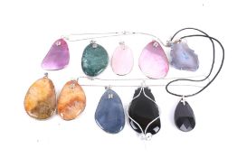 Ten various hardstone pendants in various designs and colours, some stained.
