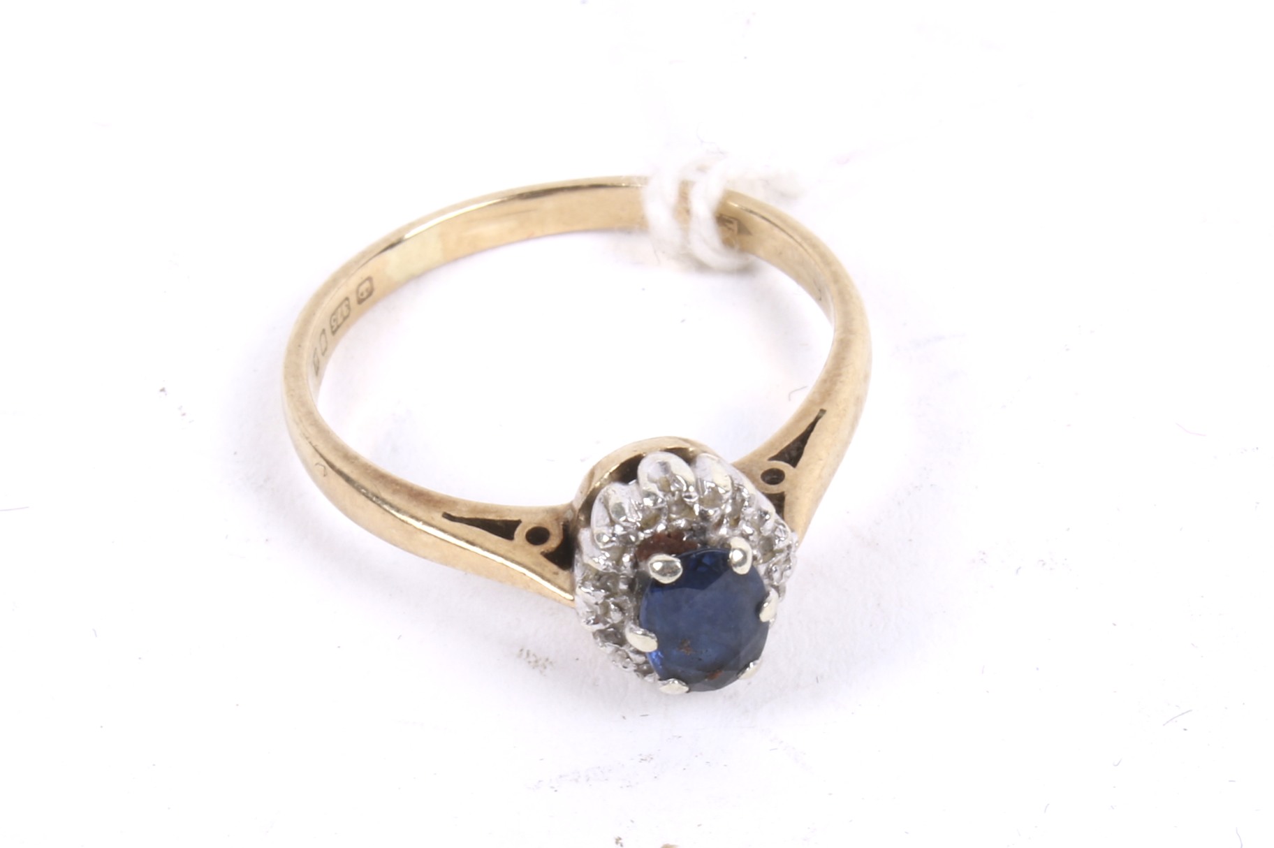 A 9ct gold sapphire and diamond oval cluster ring.