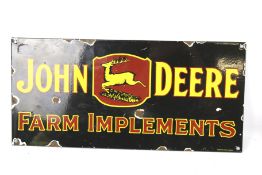 A reproduction 'John Deere Farm Implements' enamel advertising sign.