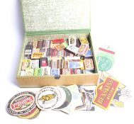 An assorted matchbox and beer mat collection.