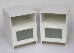 A pair of contemporary white bedside cabinets.