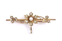 An early 20th century gold and half-pearl floral fob brooch.
