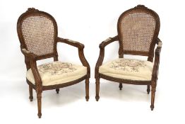 A pair of Victorian armchairs.