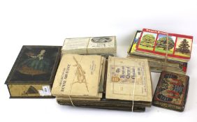 A collection of cigarette cards and two vintage tins.