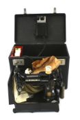 A vintage Singer 222K 'Featherweight' portable electric sewing machine.